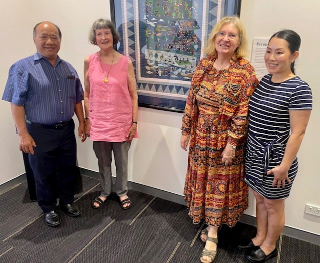 2 Hmong story cloth pia thao and julanne sweeney with maria friend and tao vue with the framed story cloth at innisfail library