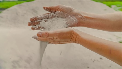Hands pouring sand